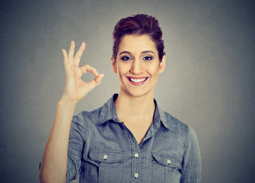 Young woman gesturing OK sign