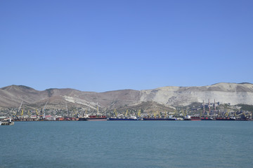 Fototapeta premium Cargo port with port cranes. Sea bay and mountainous coast.