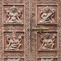 Detail wooden carved door in hindu temple, Kathmandu, Nepal background. Close up