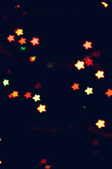 Christmas, New Year background with beautiful stars bokeh of colorful garland lights