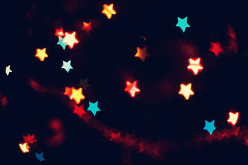 Christmas, New Year background with beautiful stars bokeh of colorful garland lights