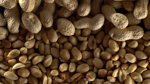 Close up of shelled peanuts rotating.