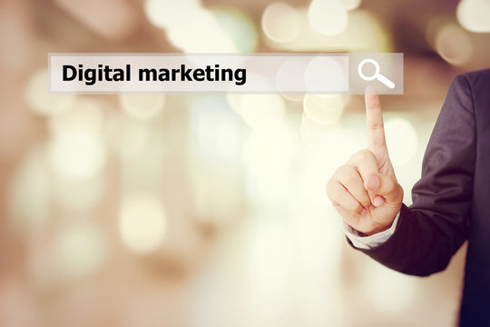 Businessman hand touch search bar with digital marketing word ov