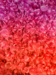 Fluffy pink and orange wool which can be used as a background. Space for text.