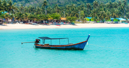 tilt shift of fishing boat in the blue sea at coast of  Thailand