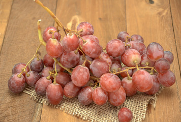 Fresh red grapes on a wooden floor