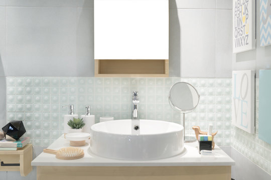 Interior of bathroom with sink basin faucet and mirror. Modern d
