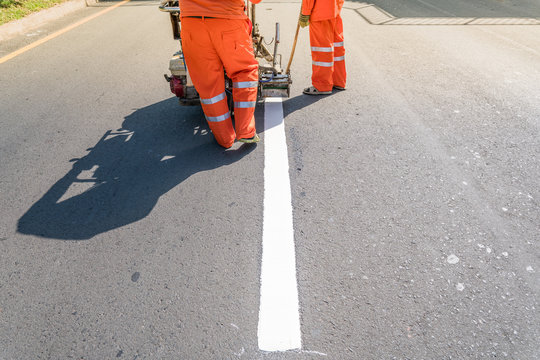 Thermoplastic Spray Marking Machine During Road Construction.
Worker Painting White Line On The Street Surface (Road Worker Painting)
