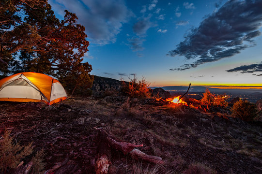 tent camping in Sedona Arizona by a campfire over the city dusk