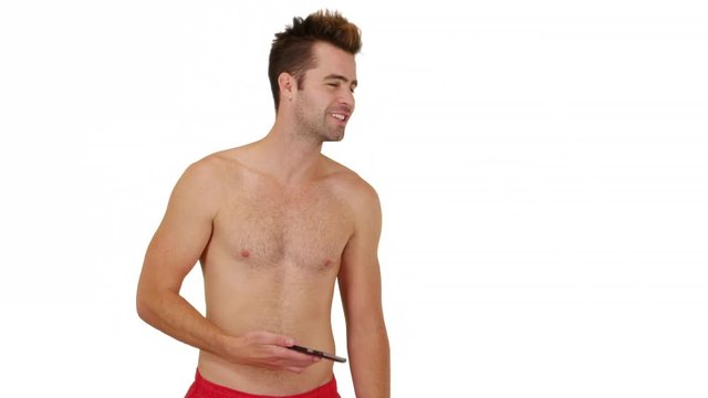 Happy man in swimsuit standing in front of white background with copy space