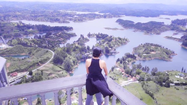 Liberty and freedom of woman in panoramic view of the islands of Guatape, Colombia. Slow motion