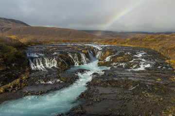 Bruarfoss Waterfall and rainbow in Iceland.