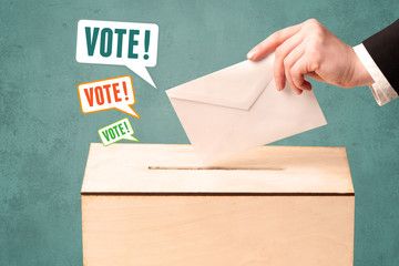 placing a voting slip into a ballot box