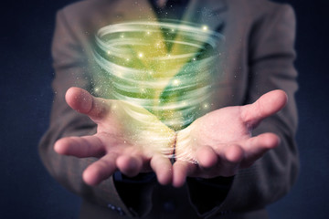 Businessman holding green tornado