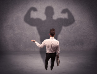 Successful businessman with strong shadow