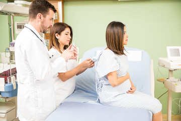 Fototapeta premium Pregnant woman receiving medical attention