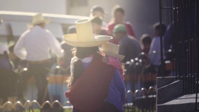 Indigenous woman holding her child wearing a typical hat. Cajamarca Peru. Slow motion.