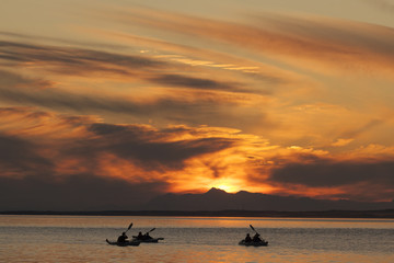 Kayaking on Skilak Lake at sunset, Alaska.