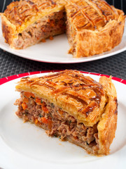 Homemade meat pie from ground beef and vegetables. Vertical shot