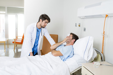 doctor consulting patient lying on hospital bed talking worried giving bad news about the diagnose
