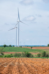 Wind turbines with blue sky and brown soil at daylight
