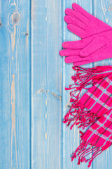 Gloves and shawl for woman on old boards, clothing for autumn or winter, copy space for text