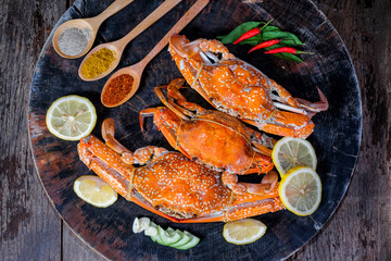 Jumbo crabs with spices on wood cutting board