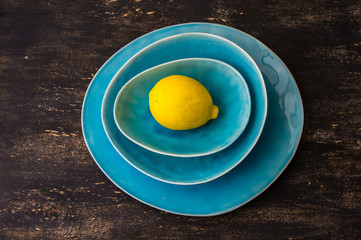 Yellow lemon on rustic plates