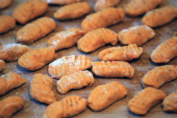 Fresh home made hokkaido pumpkin gnochi on wooden desk.