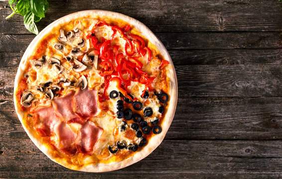Assorted Pizza with bacon, mushrooms, peppers and olives on the