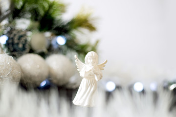 Christmas decoration with green pine, blue garland, white angel at white background. New year and christmas concept. Celebration and decoration.