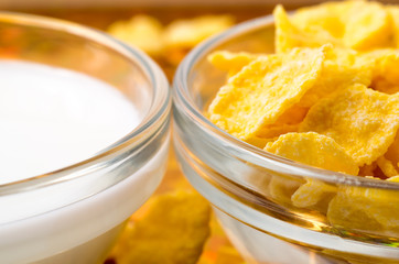 Transparent cups with milk and cornflakes close-up