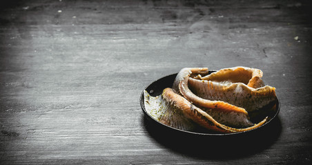 Fillet of salted herring on the plate