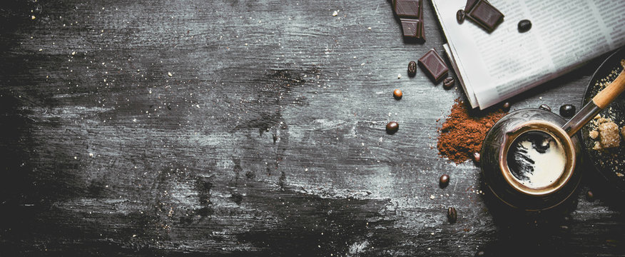 Brewed Coffee Pot With Fresh Newspaper And Bitter Chocolate.