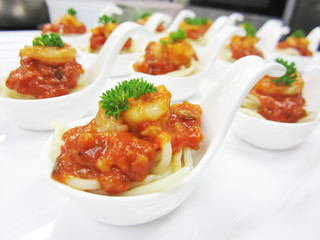 Spaghetti shrimp lasagna  in white spoon decorated with parsley . Top view.