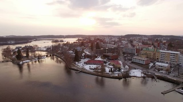 Aerial panning shot of a cityscape and a castle by a lake in Finland.