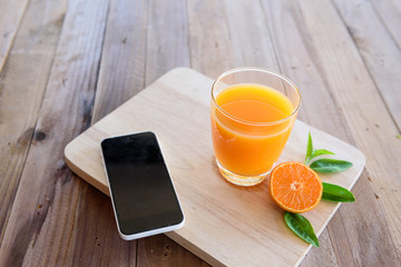 orange juice on wooden background © sueb9872