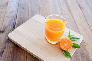 Orange juice on wooden background © sueb9872