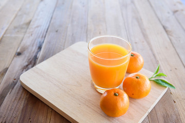 Orange juice on wooden background © sueb9872