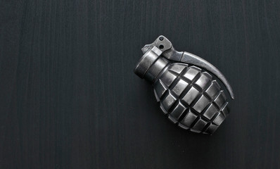 Silver color grenade lighter isolated on wooden background