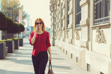 Pretty woman using cellphone outdoors.

