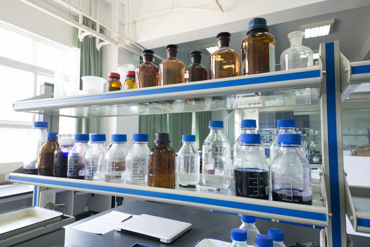 Chemical Bottles in Laboratory Shelf