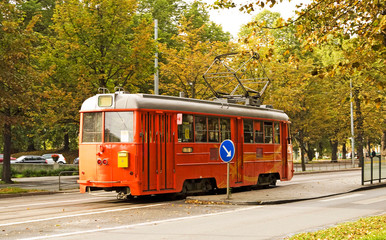 Fototapeta na wymiar Red tram on street of Stockholm, Sweden