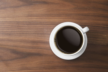 white coffee cup and hot espresso coffee on wooden table. top view