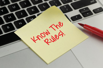 Know The Rules! sticky note pasted on the keyboard