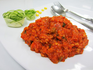 lasangna sauce from red tomatoes . Decorate the plate with Japanese cucumber rosette . focus at  lasangna sauce.