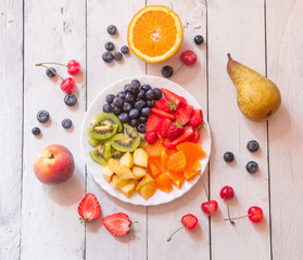 Colorful fruit salad on white table