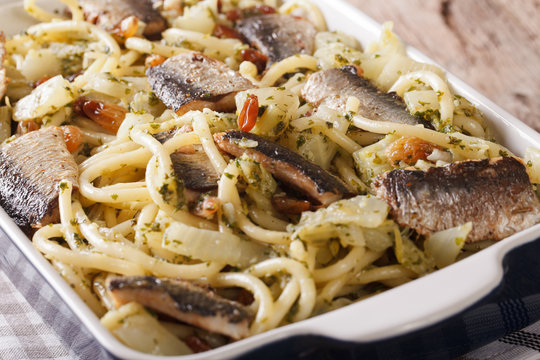 Italian pasta with sardines, fennel, raisins and pine nuts macro. horizontal