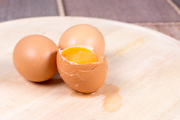 Eggs with yolk on table with blurred background