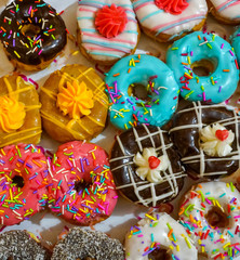 Colorful donuts on bakery display for Hanukkah celebration. Selective focus.